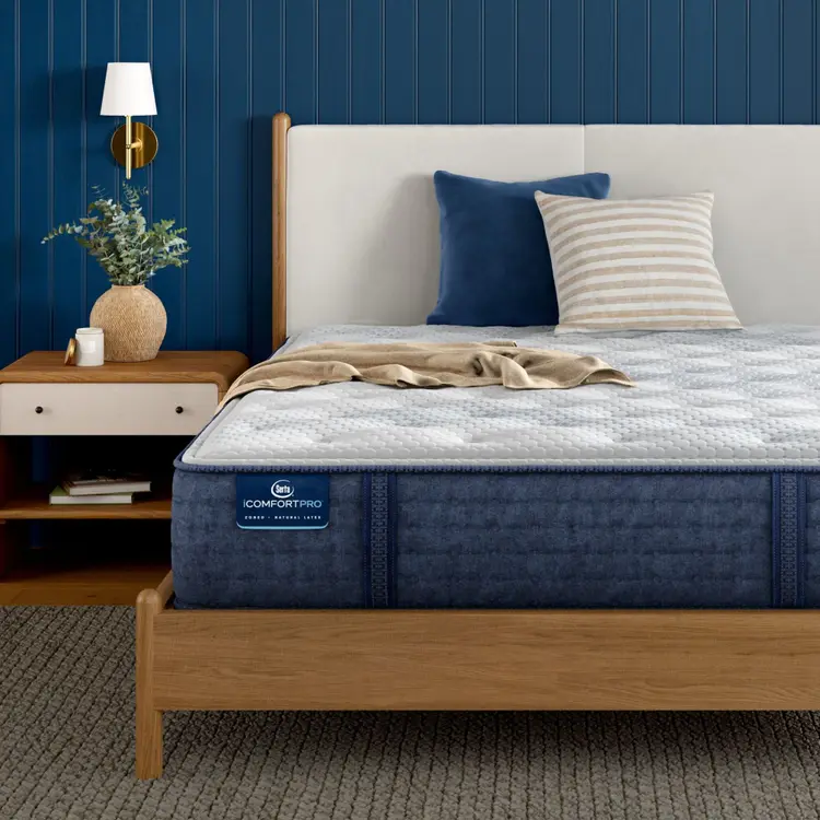 Corner of iComfortPro Ambrose Plush Mattress sitting in a brown bedframe || feel: plush || level: Level 2