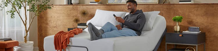 Man relaxing on adjustable bed in cozy room