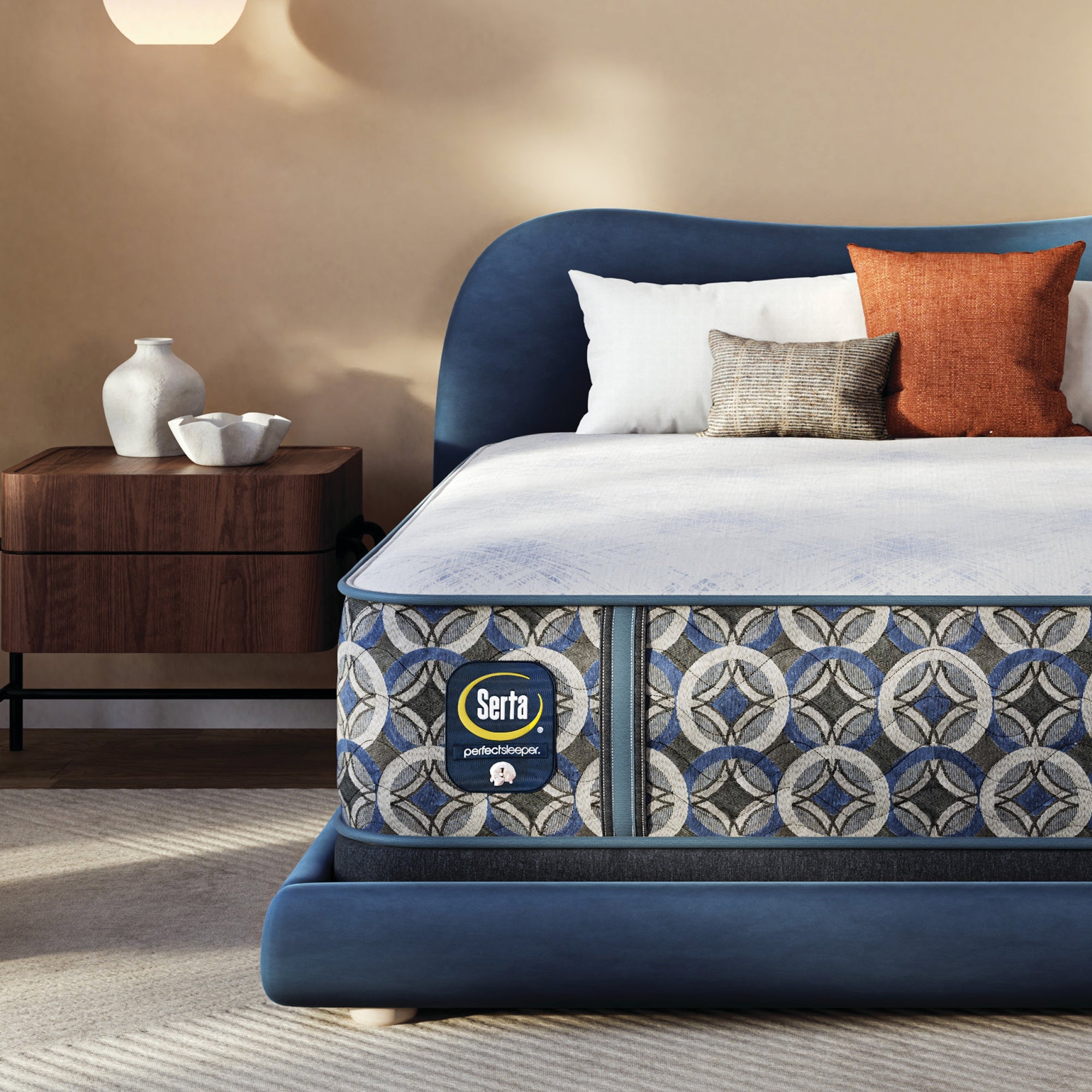 Serta pefect sleeper hybrid plush mattress with decorative headboard and pillows in a bedroom setting