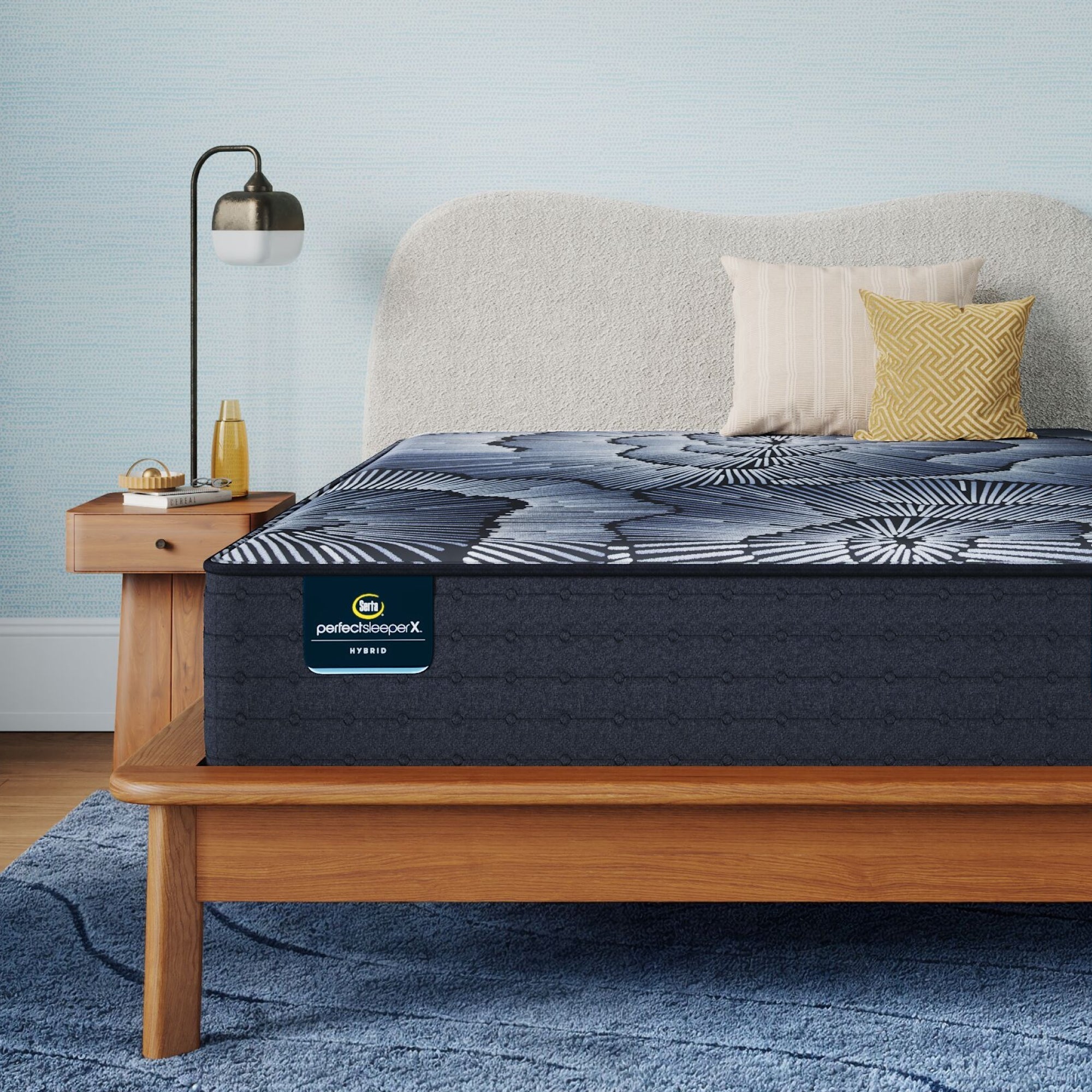 Perfect Sleeper X Hybrid Kendall Medium Mattress sitting in a brown bedframe || feel: medium || level: Level 1
