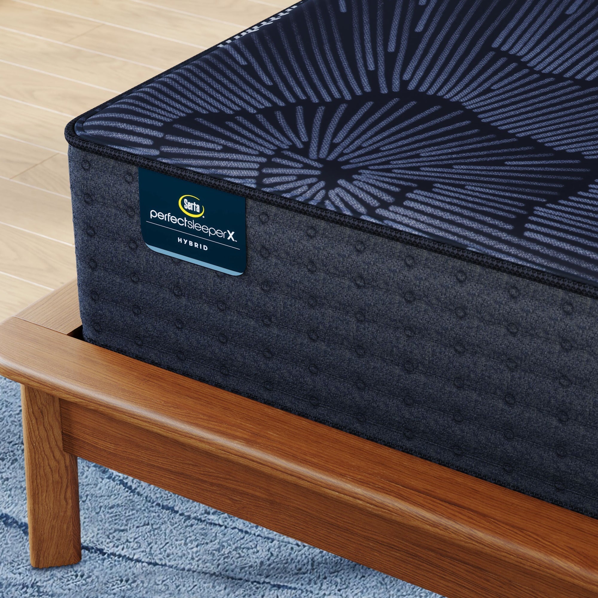 Corner of Perfect Sleeper X Hybrid Prescot Plush Mattress sitting in a brown bedframe || feel: Plush || level: Level 2