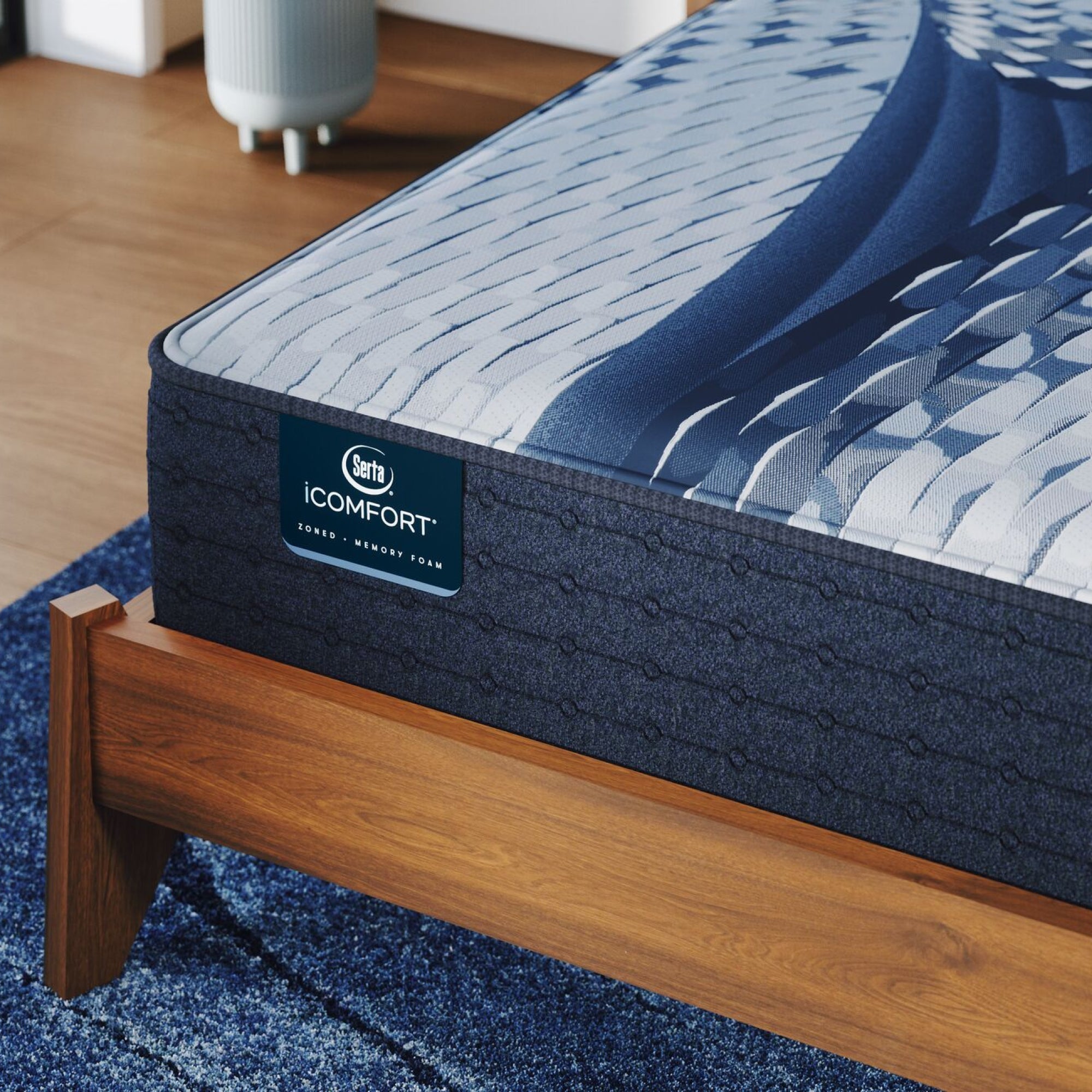 Corner of a iComfort Aveda Medium Mattress sitting in a brown bedframe || feel: medium || level: Standard - 12"