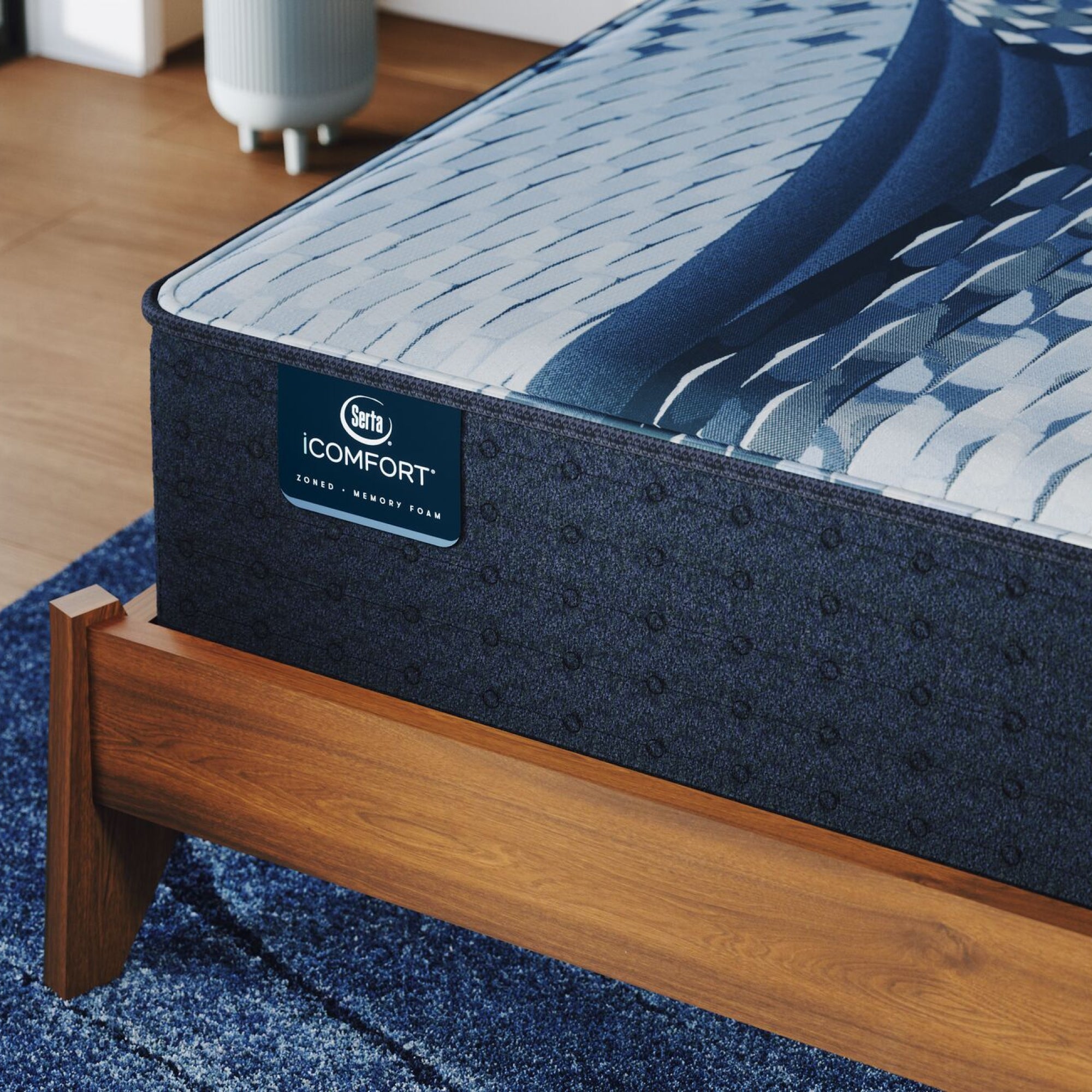 Corner of a iComfort Iona Medium Mattress sitting in a brown bedframe || feel: medium || level: Standard - 13"