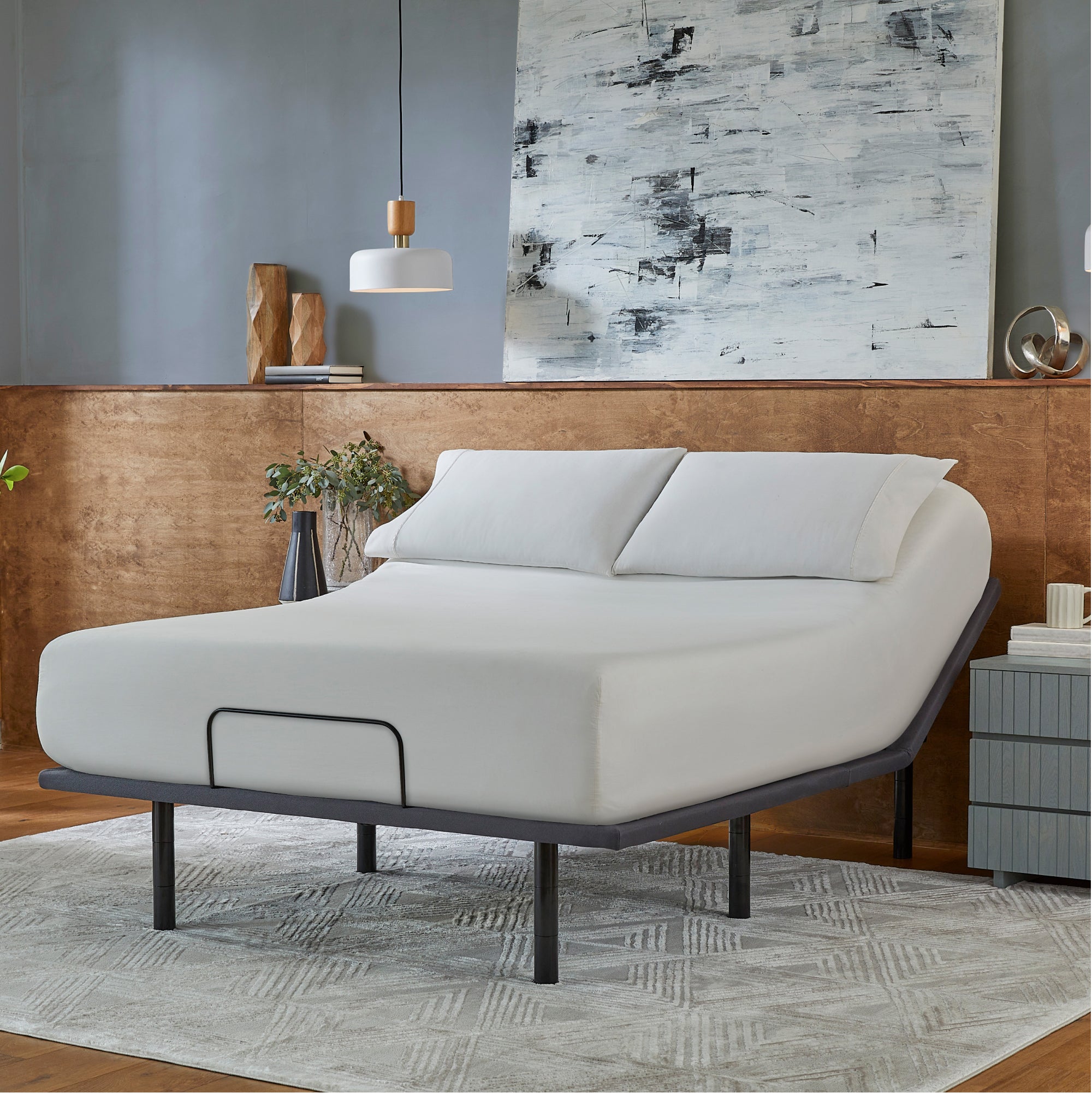 Baselogic Silver Adjustable Base with a white mattress sitting on top of it.