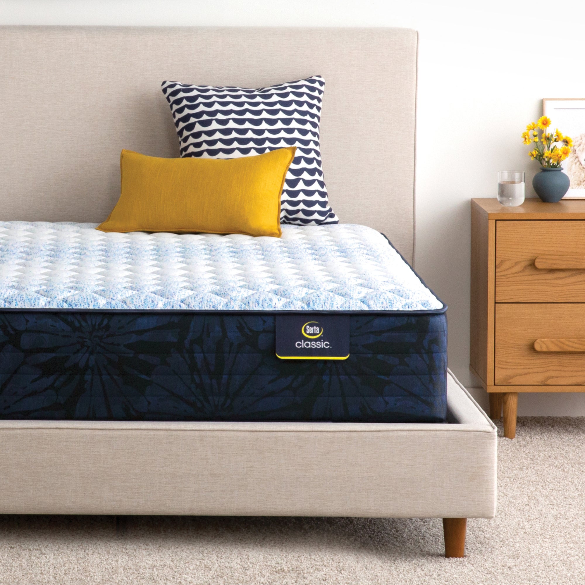 Serta classic dorian firm mattress sitting in a beige bed frame ||feel: firm||level: standard